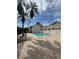 Community pool area with lounge chairs and palm trees under a bright blue sky at 5713 Townhouse Dr # 5713, New Port Richey, FL 34652