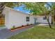 A backyard featuring a white exterior and a brick pathway on a sunny day at 5753 2Nd N Ave, St Petersburg, FL 33710