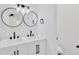 Bathroom features double sinks with black fixtures, a toilet, and modern lighting at 5753 2Nd N Ave, St Petersburg, FL 33710