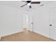 Bright bedroom features light-colored wood floors, a ceiling fan, and white painted walls at 5753 2Nd N Ave, St Petersburg, FL 33710