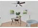 Bright room featuring a ceiling fan, light wood floors, two windows, and a modern desk area at 5753 2Nd N Ave, St Petersburg, FL 33710