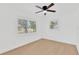 A bright bedroom with light-colored floors, two windows, and fresh white paint at 5753 2Nd N Ave, St Petersburg, FL 33710