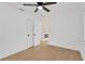 Bright bedroom features light-colored wood floors, a ceiling fan, and a doorway to another room at 5753 2Nd N Ave, St Petersburg, FL 33710