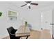 Bright room with a ceiling fan, light wood floors, one window, a modern desk, and an upholstered arm chair at 5753 2Nd N Ave, St Petersburg, FL 33710