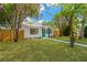 Charming single-story home featuring fresh green lawn and a painted front door at 5753 2Nd N Ave, St Petersburg, FL 33710
