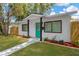 Inviting single-story home with a painted front door and well-manicured lawn and landscaping at 5753 2Nd N Ave, St Petersburg, FL 33710