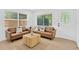 Bright living room with a tan sofa and large windows at 5753 2Nd N Ave, St Petersburg, FL 33710