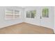 Bright room with pristine white walls, stylish door and light hardwood floors with natural light at 5753 2Nd N Ave, St Petersburg, FL 33710
