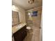 Bathroom featuring a tiled walk-in shower, granite vanity, and tile flooring at 6339 Delaware Ave, New Port Richey, FL 34653