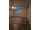 Empty bedroom with tile floors, a ceiling fan, and natural light from a window at 6339 Delaware Ave, New Port Richey, FL 34653