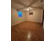 Empty bedroom featuring a ceiling fan, wood floors, and natural light at 6339 Delaware Ave, New Port Richey, FL 34653