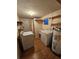 Functional laundry room with washer, dryer, sink, and additional storage space at 6339 Delaware Ave, New Port Richey, FL 34653