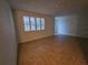 Neutral living area with tile flooring and a large window providing natural light at 6339 Delaware Ave, New Port Richey, FL 34653