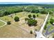 Expansive aerial view of a property with a charming home, surrounded by lush greenery and spacious land at 7089 Goodway, Brooksville, FL 34602