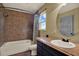 Bathroom with bathtub and shower and a round mirror at 7089 Goodway, Brooksville, FL 34602
