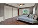 Inviting bedroom featuring wood floors, lots of storage and peaceful backyard views at 7089 Goodway, Brooksville, FL 34602