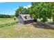 Exterior shot of the home with mature trees and a wooden fence at 7089 Goodway, Brooksville, FL 34602