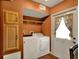 Laundry room with a washer and dryer and wood cabinets at 7089 Goodway, Brooksville, FL 34602