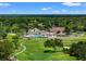 Stunning aerial view of the golf course and clubhouse, showcasing manicured greens and lush landscaping at 7367 Willow Brook Dr, Spring Hill, FL 34606