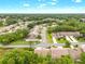 Wide aerial view of a charming neighborhood featuring well-manicured lawns and tree-lined streets at 7367 Willow Brook Dr, Spring Hill, FL 34606
