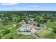 Aerial view of golf course community with pool, tennis courts and verdant landscaping at 7367 Willow Brook Dr, Spring Hill, FL 34606