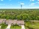 Scenic aerial view of the homes, featuring lush greenery and a communications tower at 7367 Willow Brook Dr, Spring Hill, FL 34606