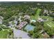 Aerial view of tennis courts and community center with pool nestled in trees at 7367 Willow Brook Dr, Spring Hill, FL 34606