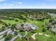 Aerial view of golf course community with pool, clubhouse, and lush fairways at 7367 Willow Brook Dr, Spring Hill, FL 34606