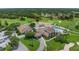 Aerial view of the community clubhouse featuring a pool, putting green and golf course at 7367 Willow Brook Dr, Spring Hill, FL 34606