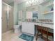 Light filled bathroom features a granite countertop vanity, shower, and vanity area at 7367 Willow Brook Dr, Spring Hill, FL 34606
