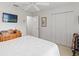 Spacious bedroom with ceiling fan, closet, and television at 7367 Willow Brook Dr, Spring Hill, FL 34606