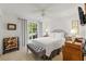 This bright bedroom offers a large window, ceiling fan, and well appointed furniture at 7367 Willow Brook Dr, Spring Hill, FL 34606