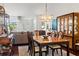 Elegant dining room with a decorative chandelier, hardwood floors, and ample natural light at 7367 Willow Brook Dr, Spring Hill, FL 34606
