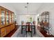 Bright dining room with hardwood floors, elegant chandelier, and sliding glass doors at 7367 Willow Brook Dr, Spring Hill, FL 34606