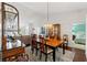 Elegant dining area featuring stylish light fixture and hardwood floors adjacent to living area at 7367 Willow Brook Dr, Spring Hill, FL 34606