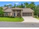Inviting home with well-manicured lawn, screened garage and a welcoming front entrance at 7367 Willow Brook Dr, Spring Hill, FL 34606