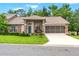Inviting home with well-manicured lawn, screened garage and a welcoming front entrance at 7367 Willow Brook Dr, Spring Hill, FL 34606