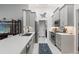 Modern kitchen featuring sleek gray cabinetry, stainless steel appliances, and stylish backsplash at 7367 Willow Brook Dr, Spring Hill, FL 34606