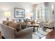 Bright living room with vaulted ceilings, comfortable seating, and a large window at 7367 Willow Brook Dr, Spring Hill, FL 34606