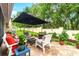 Inviting patio area with outdoor seating, lush greenery, and a shaded space for relaxing at 7367 Willow Brook Dr, Spring Hill, FL 34606