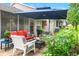 Cozy outdoor patio with comfortable seating, umbrella, and views of the surrounding greenery at 7367 Willow Brook Dr, Spring Hill, FL 34606