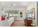 Bright sunroom features a ceiling fan, door to the outside, and space for crafting and other hobbies at 7367 Willow Brook Dr, Spring Hill, FL 34606