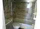 Bathroom featuring a shower/tub combo with a glass door, tile surround, and modern vanity at 7419 E Comanche Ave, Tampa, FL 33610