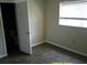 The bedroom shows hardwood floors, a window, and an open door to the bathroom at 7419 E Comanche Ave, Tampa, FL 33610