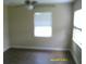 Bright bedroom with hardwood floors and a window providing natural light at 7419 E Comanche Ave, Tampa, FL 33610
