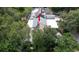 Aerial view of the house highlighting the roof and surrounding green landscape at 7501 Woodbox Row, Hudson, FL 34667