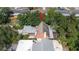 An aerial view of the home highlighting roof and surrounding mature trees at 7501 Woodbox Row, Hudson, FL 34667