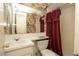 Vintage bathroom with a colorful wallpaper and white fixtures at 7501 Woodbox Row, Hudson, FL 34667