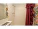 Bathroom featuring a shower with a shower curtain at 7501 Woodbox Row, Hudson, FL 34667