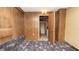 Bedroom showing wood paneling and patterned carpet with doorway to another room at 7501 Woodbox Row, Hudson, FL 34667
